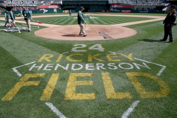 The grounds crew prepares Rickey Henderson Field prior to the Oakland Athletics opening day MLB game against the Los Angeles Angels at the Coliseum in Oakland, Calif., on Thursday, March 28, 2019. (Anda Chu/Bay Area News Group)