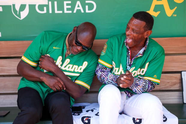 Oakland Athletics legends Dave Stewart and Rickey Henderson share a moment in the dugout before the Oakland Athletics' last game played at the Coliseum in Oakland, Calif., on Thursday, Sept. 26, 2024. The Athletics played the Texas Rangers for their final home game before moving to Sacramento next season. (Ray Chavez/Bay Area News Group)