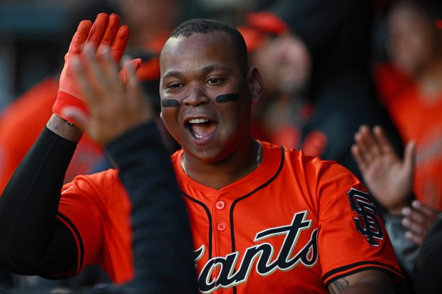 San Francisco Giants' Rafael Devers (16) is congratulated in the dugout after hitting a solo home run in the first inning of their MLB game at Oracle Park in San Francisco, Calif., on Friday, Aug. 8, 2025. (Jose Carlos Fajardo/Bay Area News Group)