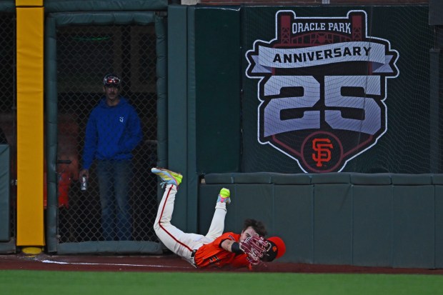 San Francisco Giants' Drew Gilbert (61) dives to catch a ball hit by Washington Nationals' Jacob Young (30) in the third inning of their MLB game at Oracle Park in San Francisco, Calif., on Friday, Aug. 8, 2025. (Jose Carlos Fajardo/Bay Area News Group)