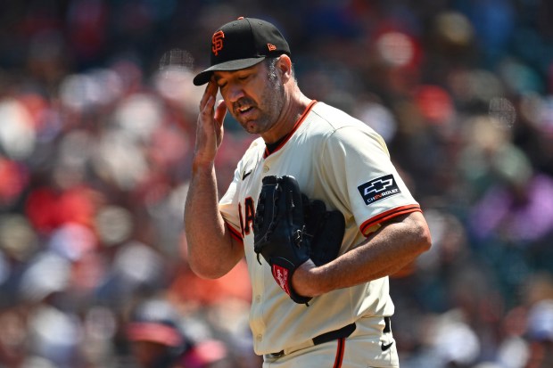 San Francisco Giants pitcher Justin Verlander (35) wipes his face...