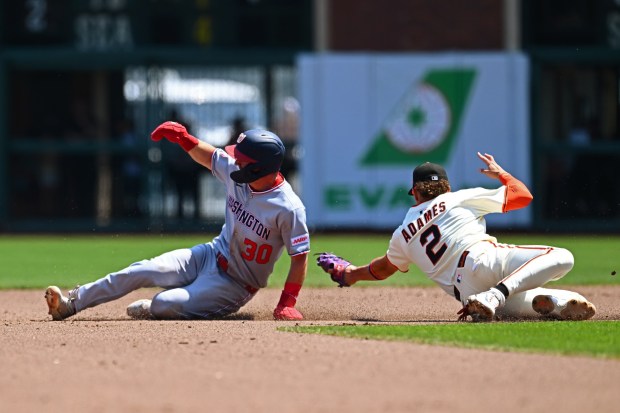 Washington Nationals' Jacob Young (30) steals second base as San Francisco Giants' Willy Adames (2) is late on the tag in the fourth inning of their MLB game at Oracle Park in San Francisco, Calif., on Sunday, Aug. 10, 2025. The Washington Nationals defeated the San Francisco Giants 8-0. (Jose Carlos Fajardo/Bay Area News Group)