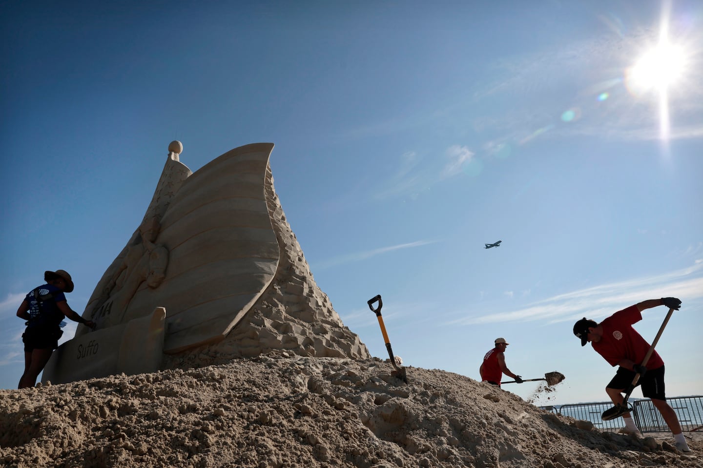 Sand sculptor Melineige Beauregard (left) worked on “Revolutions Start Here,” the centerpiece of the 21st annual Revere Beach International Sand Sculpting Festival in Revere on July 23. 