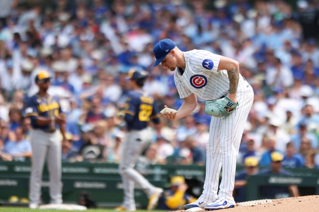 Chicago Cubs pitcher Cade Horton (22) pick up the rosin bag after walking Milwaukee Brewers outfielder Christian Yelich (22) during the third inning at Wrigley Field on Monday, Aug. 18, 2025. (Eileen T. Meslar/Chicago Tribune)