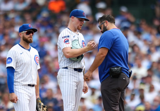 Chicago Cubs pitcher Cade Horton (22) is checked on by a trainer during the third inning against the Milwaukee Brewers at Wrigley Field on Monday, Aug. 18, 2025. (Eileen T. Meslar/Chicago Tribune)