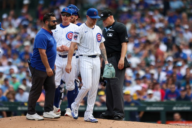 Chicago Cubs pitcher Cade Horton (22) leaves the game after being checked on by a trainer during the third inning against the Milwaukee Brewers at Wrigley Field on Monday, Aug. 18, 2025. (Eileen T. Meslar/Chicago Tribune)