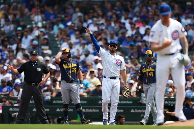 Chicago Cubs first base Michael Busch (29) signals to his teammates that there are tow outs during the second inning against the Milwaukee Brewers at Wrigley Field on Monday, Aug. 18, 2025. (Eileen T. Meslar/Chicago Tribune)