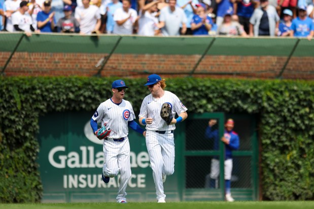 Chicago Cubs outfielder Pete Crow-Armstrong (4) speaks to outfielder Owen Caissie (19) after Caissie caught a long line drive to end the top of the second inning against the Milwaukee Brewers at Wrigley Field on Monday, Aug. 18, 2025. (Eileen T. Meslar/Chicago Tribune)