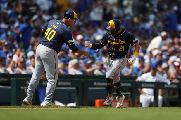 Milwaukee Brewers third base coach Jason Lane (40) celebrates with Brewers' Caleb Durbin (21) after he hit a home run during the fifth inning against the Chicago Cubs at Wrigley Field on Monday, Aug. 18, 2025. (Eileen T. Meslar/Chicago Tribune)