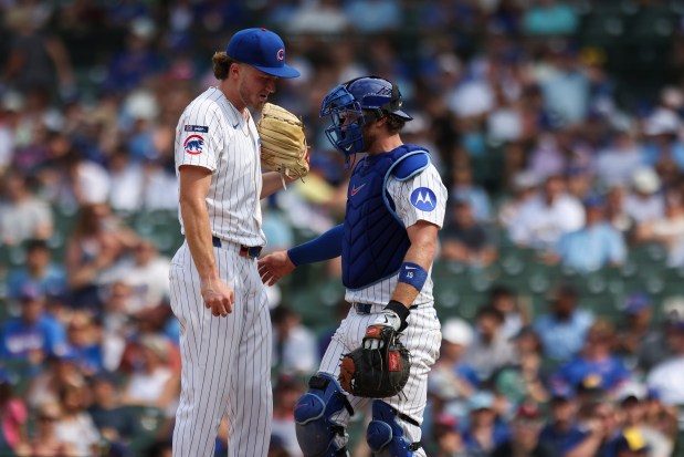 Chicago Cubs catcher Carson Kelly (15) speaks to pitcher Gavin Hollowell during the eighth inning against the Milwaukee Brewers at Wrigley Field on Monday, Aug. 18, 2025. (Eileen T. Meslar/Chicago Tribune)