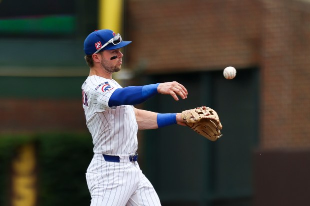 Chicago Cubs second base Nico Hoerner (2) throws to first base after fielding the ball during the first inning against the Pittsburgh Pirates at Wrigley Field on Sunday, Aug. 17, 2025. (Eileen T. Meslar/Chicago Tribune)