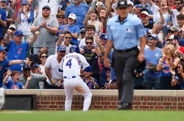 Chicago Cubs fans celebrate with Chicago Cubs outfielder Pete Crow-Armstrong (4) after he scored a run during the second inning against the Pittsburgh Pirates at Wrigley Field on Sunday, Aug. 17, 2025. (Eileen T. Meslar/Chicago Tribune)