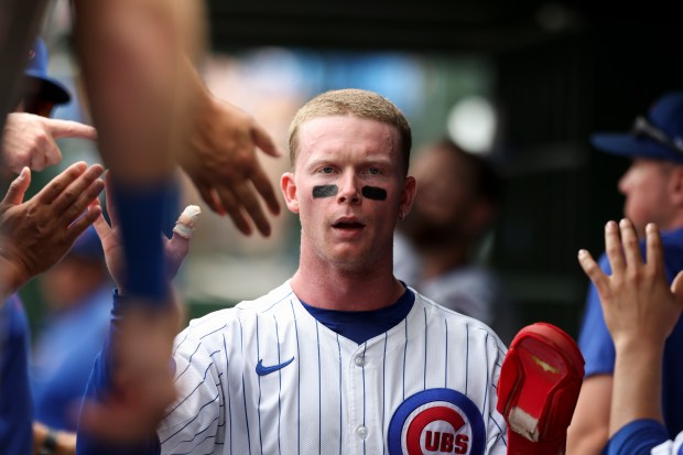 Chicago Cubs outfielder Pete Crow-Armstrong (4) gets high-fives from his teammates after scoring a run during the second inning against the Pittsburgh Pirates at Wrigley Field on Sunday, Aug. 17, 2025. (Eileen T. Meslar/Chicago Tribune)