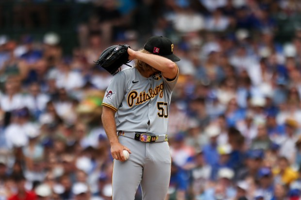 Pittsburgh Pirates pitcher Carmen Mlodzinski (50) wipes his face while pitching during the second inning at Wrigley Field against the Chicago Cubs on Sunday, Aug. 17, 2025. (Eileen T. Meslar/Chicago Tribune)