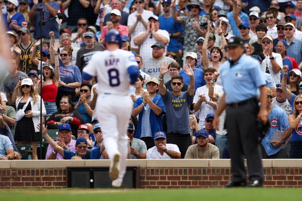 Chicago Cubs fans celebrate after Chicago Cubs shortstop Dansby Swanson (7) hit an RBI double to get Chicago Cubs outfielder Ian Happ (8) home during the fifth inning against the Pittsburgh Pirates at Wrigley Field on Sunday, Aug. 17, 2025. (Eileen T. Meslar/Chicago Tribune)