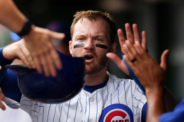Chicago Cubs outfielder Ian Happ (8) celebrates with teammates after shortstop Dansby Swanson (7) hit an RBI double to get him home during the fifth inning against the Pittsburgh Pirates at Wrigley Field on Sunday, Aug. 17, 2025. (Eileen T. Meslar/Chicago Tribune)