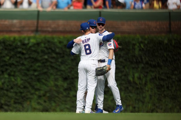 Chicago Cubs outfielders Ian Happ (8), Pete Crow-Armstrong (4), and Kyle Tucker (30) celebrate after defeating the Pittsburgh Pirates 4-3 at Wrigley Field on Sunday, Aug. 17, 2025. (Eileen T. Meslar/Chicago Tribune)