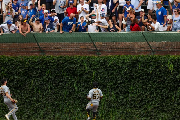 A young Cubs fan catches a ground-rule double from Chicago Cubs outfielder Ian Happ (8) that bounced into the bleachers during the eighth inning against the Pittsburgh Pirates at Wrigley Field on Sunday, Aug. 17, 2025. (Eileen T. Meslar/Chicago Tribune)