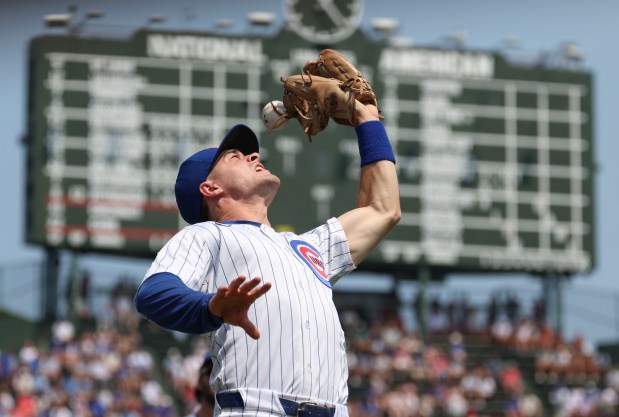 Chicago Cubs third baseman Matt Shaw drops a pop fly by Cincinnati Reds first baseman Spencer Steer in the first inning Wednesday, Aug. 6, 2025, at Wrigley Field. (Brian Cassella/Chicago Tribune)