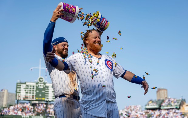 Cubs first baseman Michael Busch, left, rains bubble gum on teammate Justin Turner as they celebrate Turner's walk-off home run to defeat the Baltimore Orioles, 5-3, on Sunday, Aug. 3, 2025, at Wrigley Field. (Brian Cassella/Chicago Tribune)