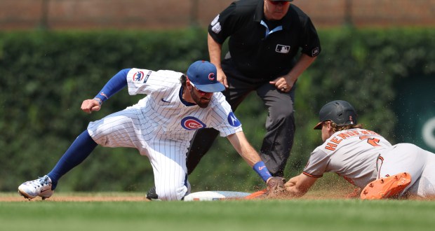 Chicago Cubs shortstop Dansby Swanson tags out Baltimore Orioles shortstop Gunnar Henderson on a stolen base attempt in the third inning Sunday, Aug. 3, 2025, at Wrigley Field. (Brian Cassella/Chicago Tribune)