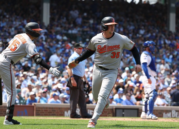 Baltimore Orioles catcher Adley Rutschman scores against the Chicago Cubs in the fourth inning Sunday, Aug. 3, 2025, at Wrigley Field. (Brian Cassella/Chicago Tribune)