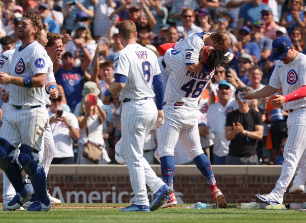 Chicago Cubs pitcher Daniel Palencia (48) picks up Chicago Cubs first base Justin Turner to celebrate Turner's walk-off home run to defeat the Baltimore Orioles, 5-3, on Sunday, Aug. 3, 2025, at Wrigley Field. (Brian Cassella/Chicago Tribune)