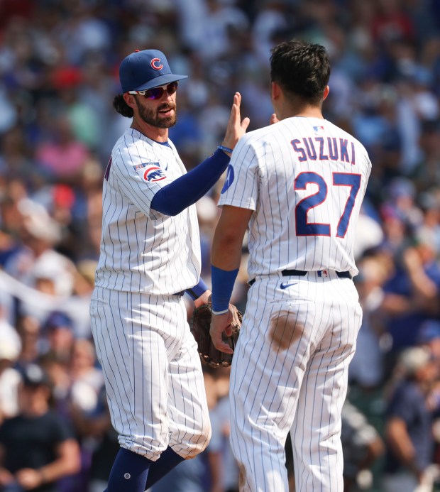 Chicago Cubs shortstop Dansby Swanson and outfielder Seiya Suzuki celebrate the win over the Cincinnati Reds on Wednesday, Aug. 6, 2025, at Wrigley Field. (Brian Cassella/Chicago Tribune)