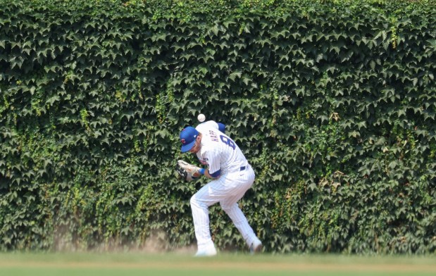 Chicago Cubs outfielder Ian Happ has a double by Cincinnati Reds outfielder Austin Hays bounce off his back in the fourth inning Wednesday, Aug. 6, 2025, at Wrigley Field. (Brian Cassella/Chicago Tribune)