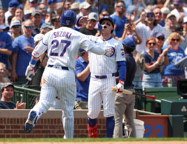 Chicago Cubs outfielder Seiya Suzuki (27) celebrates his home run with teammate Pete Crow-Armstrong against the Cincinnati Reds in the sixth inning Wednesday, Aug. 6, 2025, at Wrigley Field. (Brian Cassella/Chicago Tribune)