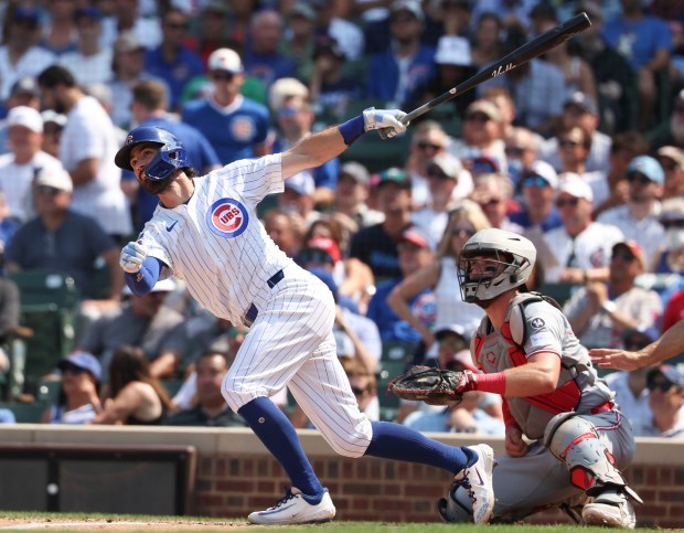 Chicago Cubs shortstop Dansby Swanson follows through with a solo home run against the Cincinnati Reds in the seventh inning Wednesday, Aug. 6, 2025, at Wrigley Field. (Brian Cassella/Chicago Tribune)
