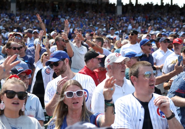 Chicago Cubs fans sing during the seventh inning stretch as they play the Cincinnati Reds on Wednesday, Aug. 6, 2025, at Wrigley Field. (Brian Cassella/Chicago Tribune)