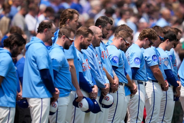 The Cubs stand for a 23-second moment of silence to honor Hall of Famer Ryne Sandberg, who died from cancer this week, before a game against the Orioles on Friday, Aug. 1, 2025, at Wrigley Field. (AP Photo/Erin Hooley)