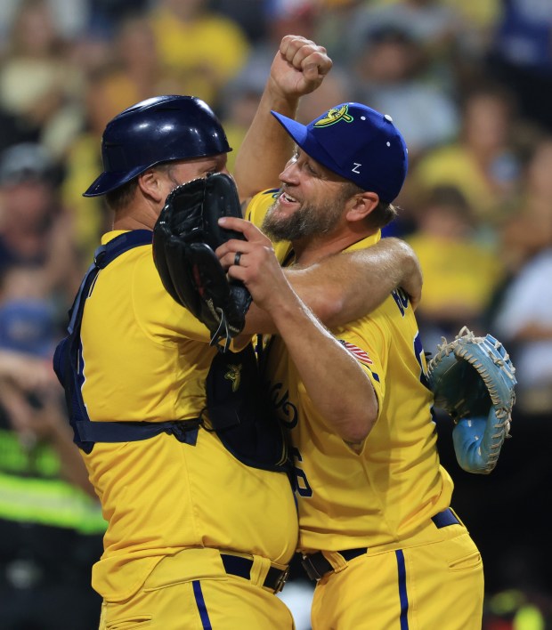 Former White Sox players A.J. Pierzynski, left, and Mark Buehrle celebrate after playing for the Savannah Bananas in the seventh inning against the Firefighters on Aug. 15, 2025, at Rate Field. (John J. Kim/Chicago Tribune)