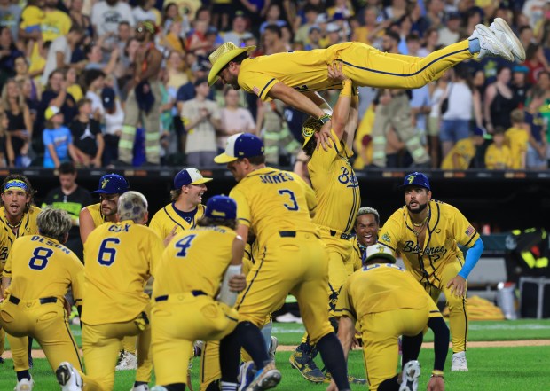 Savannah Bananas players dance after a 3-2 win over the Firefighters on Aug. 15, 2025, at Rate Field. (John J. Kim/Chicago Tribune)