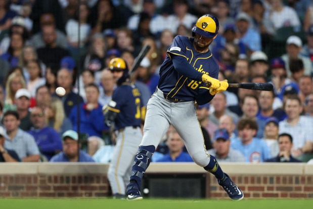 Milwaukee Brewers outfielder Blake Perkins (16) grounds out to Chicago Cubs second baseman Nico Hoerner (2) allowing Milwaukee Brewers outfielder Christian Yelich (22) to score during the second inning at Wrigley Field on Wednesday, Aug. 20, 2025, in Chicago. (Armando L. Sanchez/Chicago Tribune)
