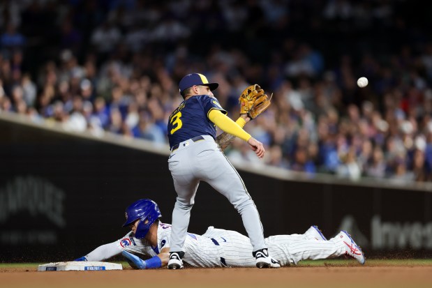 Chicago Cubs outfielder Seiya Suzuki (27) steals second base past Milwaukee Brewers shortstop Joey Ortiz (3) during the sixth inning at Wrigley Field on Wednesday, Aug. 20, 2025, in Chicago. (Armando L. Sanchez/Chicago Tribune)