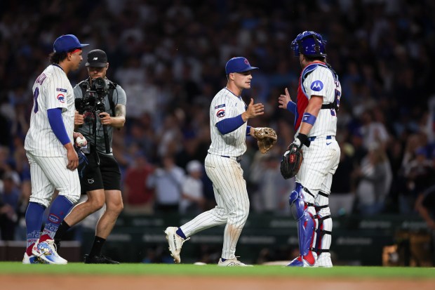 Chicago Cubs pitcher Daniel Palencia (48), Chicago Cubs third baseman Matt Shaw (6), and Chicago Cubs catcher Carson Kelly (15) celebrate after the Cubs defeated the Milwaukee Brewers, 4-3, at Wrigley Field on Wednesday, Aug. 20, 2025, in Chicago. (Armando L. Sanchez/Chicago Tribune)