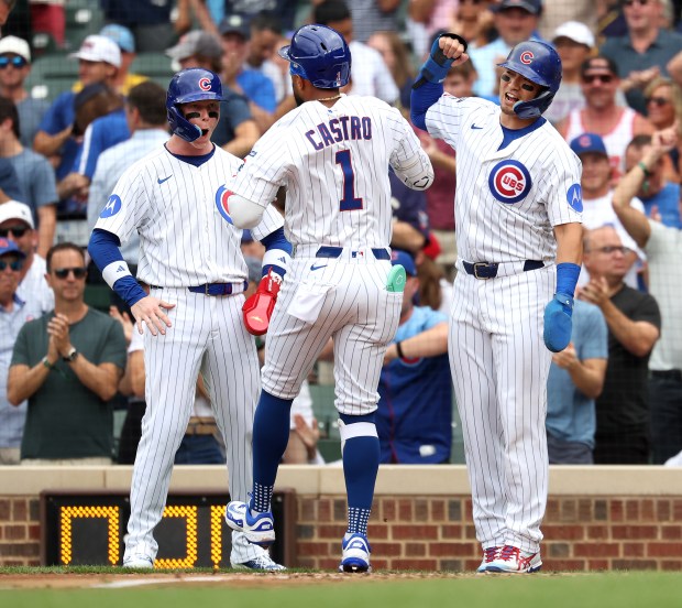 Chicago Cubs second baseman Willi Castro (1) celebrates with teammates Pete Crow-Armstrong (left) and Seiya Suzuki (right) after Castro hit a 3-run home run in the third inning of Game 1 of a doubleheader against the Milwaukee Brewers at Wrigley Field in Chicago on Aug. 19, 2025. (Chris Sweda/Chicago Tribune)