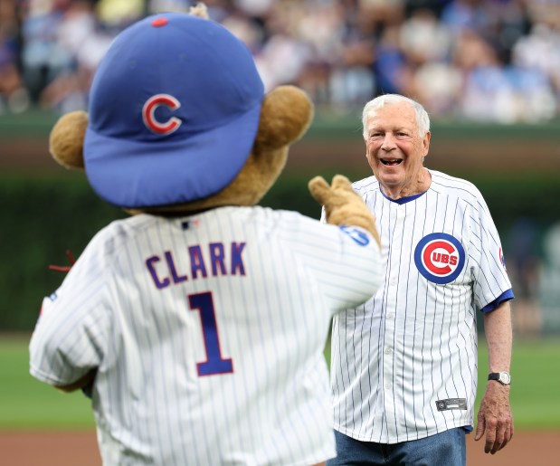 Digger Phelps, former Notre Dame men's basketball head coach, has a laugh with Chicago Cubs mascot Clark after Phelps threw out a ceremonial first pitch before Game 2 of a doubleheader between the Cubs and the Milwaukee Brewers at Wrigley Field in Chicago on Aug. 19, 2025. (Chris Sweda/Chicago Tribune)