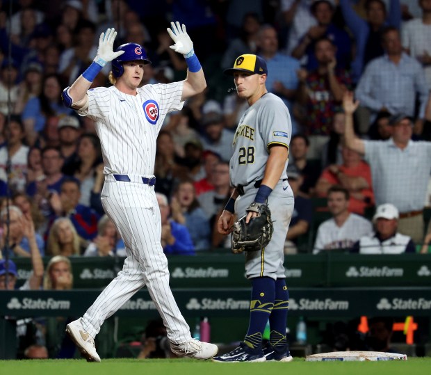 Chicago Cubs right fielder Owen Caissie celebrates at first base after driving in a run on a single in the second inning of Game 2 of a doubleheader against the Milwaukee Brewers at Wrigley Field in Chicago on Aug. 19, 2025. (Chris Sweda/Chicago Tribune)