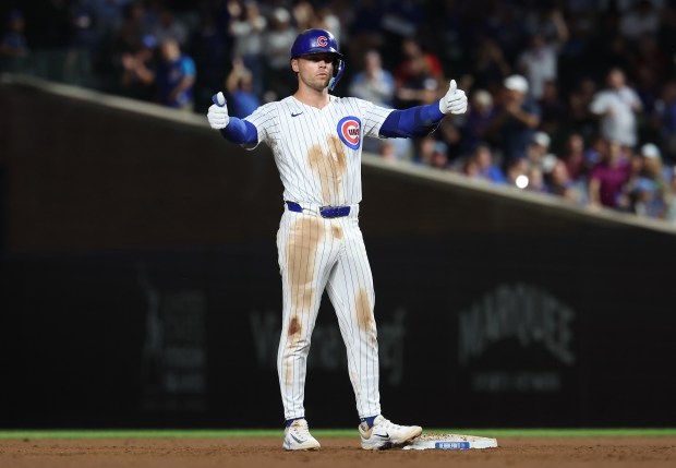 Chicago Cubs second baseman Nico Hoerner celebrates at second base after driving in a run on a single in the fifth inning of Game 2 of a doubleheader against the Milwaukee Brewers at Wrigley Field in Chicago on Aug. 19, 2025. (Chris Sweda/Chicago Tribune)