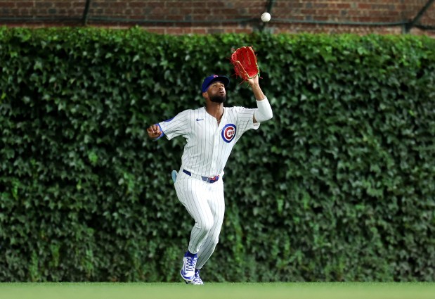 Chicago Cubs right fielder Willi Castro catches a fly ball for an out before throwing out Milwaukee Brewers second baseman Brice Turang at home plate as Turang tried to score on a sacrifice fly in the seventh inning of Game 2 of a doubleheader at Wrigley Field in Chicago on Aug. 19, 2025. (Chris Sweda/Chicago Tribune)