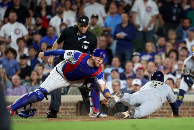 Chicago Cubs catcher Carson Kelly tags out Milwaukee Brewers second baseman Brice Turang (2) at home plate on a throw from right fielder Willi Castro in the seventh inning of game 2 of a double header at Wrigley Field in Chicago on Aug. 19, 2025. (Chris Sweda/Chicago Tribune)