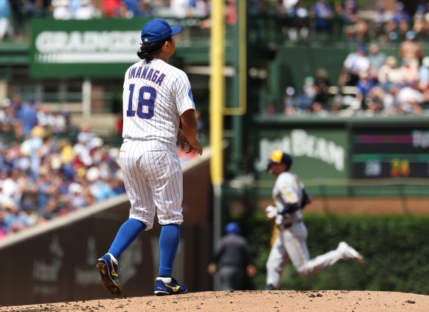 Chicago Cubs pitcher Shota Imanaga (18) stands on the mound as Milwaukee Brewers second baseman Brice Turang (background) rounds the bases after hitting a two-run home run in the second inning of a game at Wrigley Field in Chicago on Aug. 21, 2025. (Chris Sweda/Chicago Tribune)