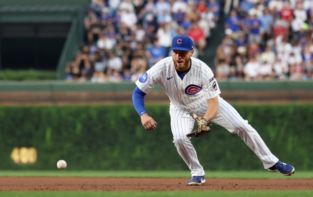 Chicago Cubs first baseman Michael Busch fields a ground ball in the third inning of a game against the Cincinnati Reds at Wrigley Field in Chicago on Aug. 5, 2025. (Chris Sweda/Chicago Tribune)