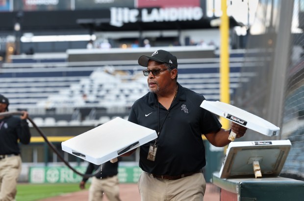 Chicago White Sox grounds crew member Nevest Coleman (cq) carries bases to the field while preparing the field for a game between the Sox and the Kansas City Royals at Rate Field in Chicago on Aug. 26, 2025. (Chris Sweda/Chicago Tribune)