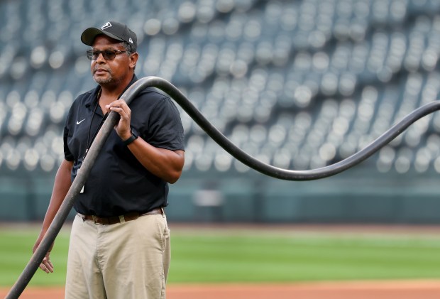 Chicago White Sox grounds crew member Nevest Coleman (cq) works alongside his colleagues to prepare the field for a game between the Sox and the Kansas City Royals at Rate Field in Chicago on Aug. 26, 2025. (Chris Sweda/Chicago Tribune)