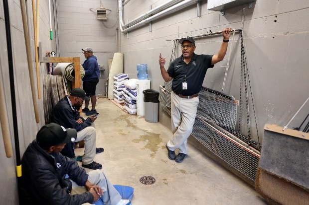 Chicago White Sox grounds crew member Nevest Coleman (cq) (right) chats with his colleagues in a tunnel while working a game between the Sox and the Kansas City Royals at Rate Field in Chicago on Aug. 26, 2025. (Chris Sweda/Chicago Tribune)