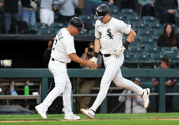 White Sox shortstop Colson Montgomery slaps hands with third-base coach Justin Jirschele after hitting a solo home run in the second inning against the Royals on Aug. 26, 2025, at Rate Field. (Chris Sweda/Chicago Tribune)